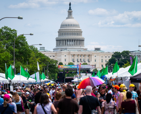 Image of festival goers on Pennsylvania Avenue in Washington, DC with the Capitol Building rising in the background.