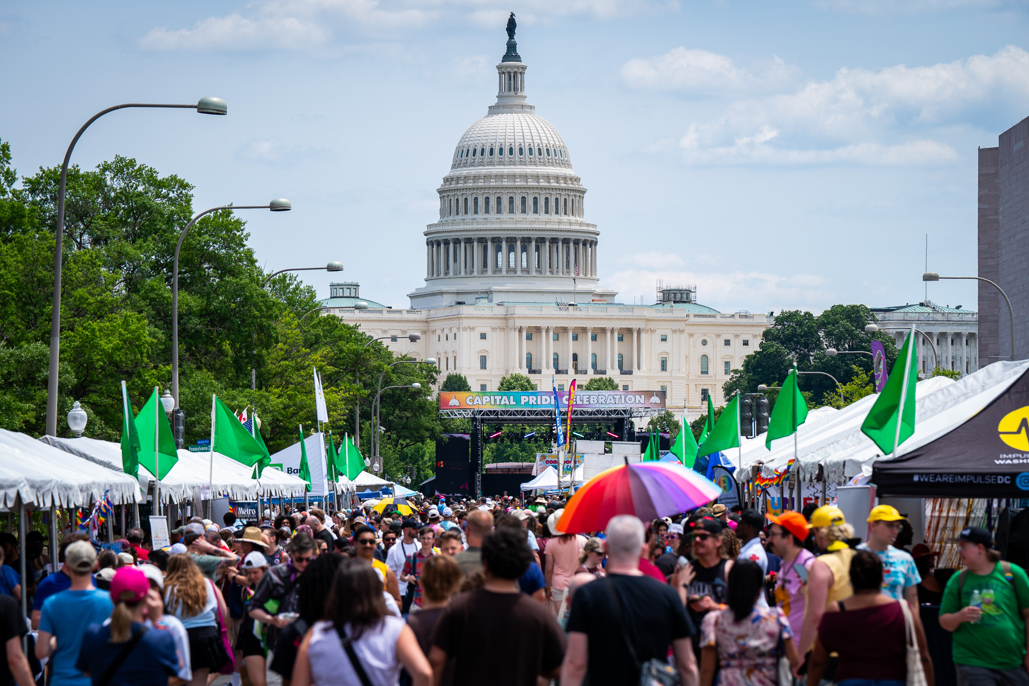 Emily Alff @alffa.one / Capital Pride Alliance Image of festival goers on Pennsylvania Avenue in Washington, DC with the Capitol Building rising in the background.